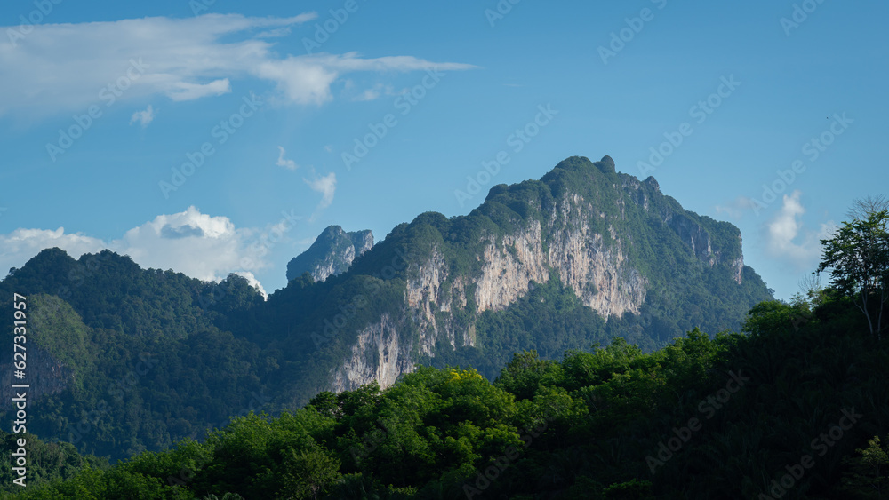Beautiful view of the greenery mountain range scape in sunny blue sky day. Landscape in nature photo.