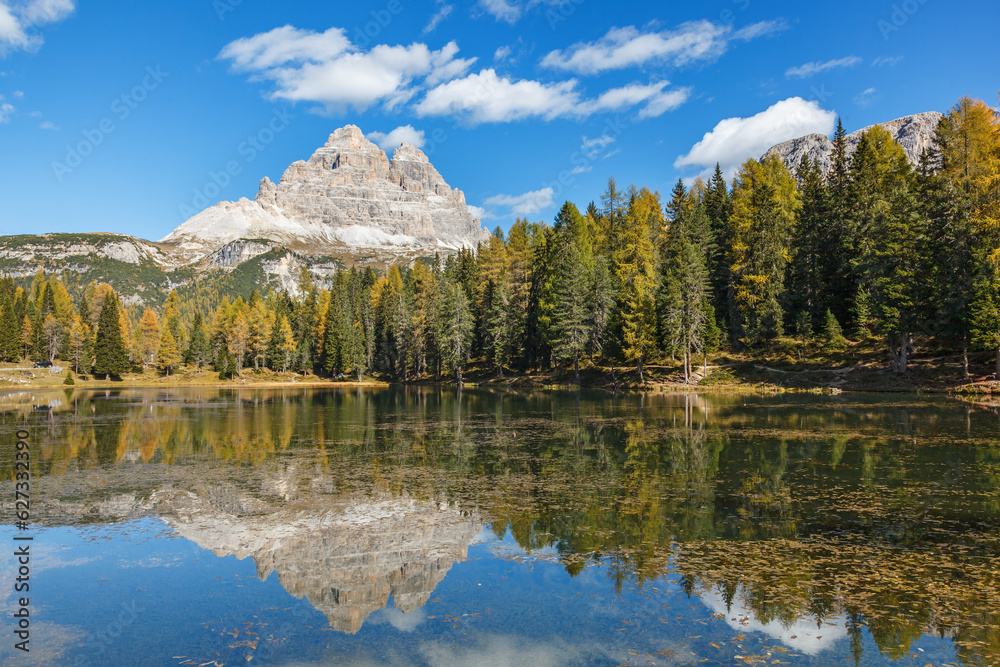 Mountain peak with reflections in a lake at autumn