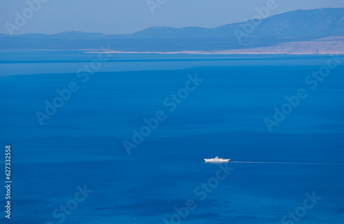 Fototapeta Naklejka Na Ścianę i Meble -  Aerial view to large cruise ship floating on sea with mountain. Travel, transportation background, Croatia