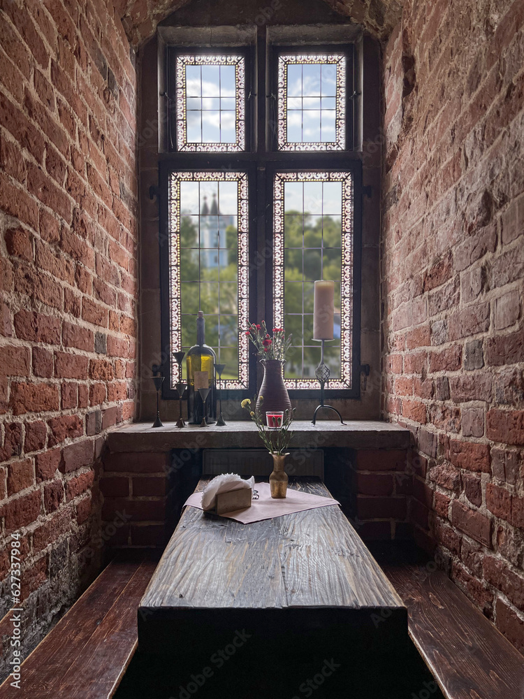 Naklejka premium Still life with bouquet of carnations on a windowsill in old building