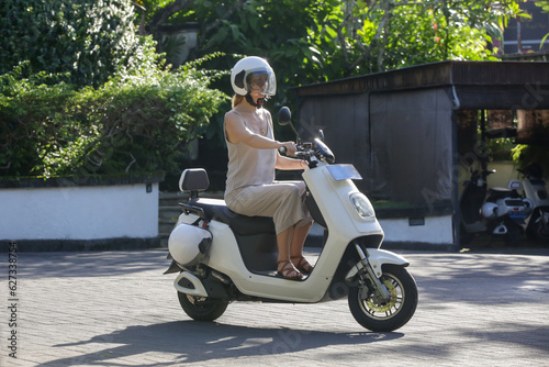 Woman tourist riding an electric scooter