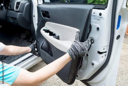 Auto mechanic remove car front door trim, Car maintenance service.