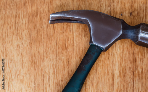 A hammer on a wooden table. AI generative
