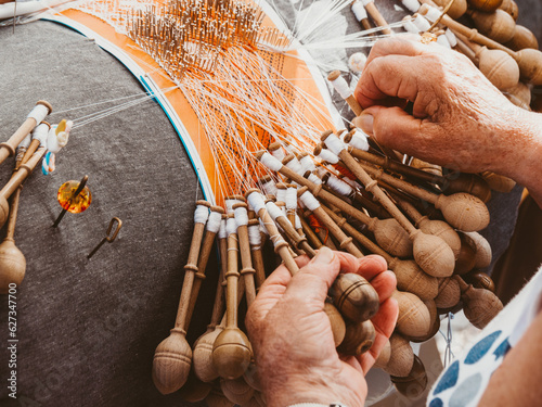 Close-up of woman hands works with bobbin lace, hand made crafting Laces photo