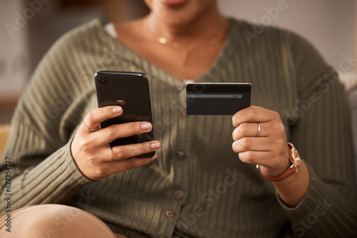 Hands, woman and credit card with phone for online shopping, digital payment and fintech account at home. Closeup of person, mobile banking and finance money for web sales, password and ecommerce app