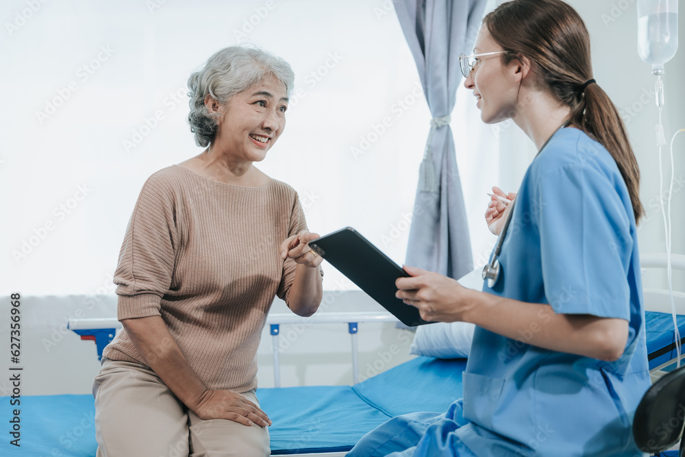 Obraz premium Young beautiful smiling doctor nurse caring to help happy senior grandmother helping old patients in rehabilitation at elderly health checkup
