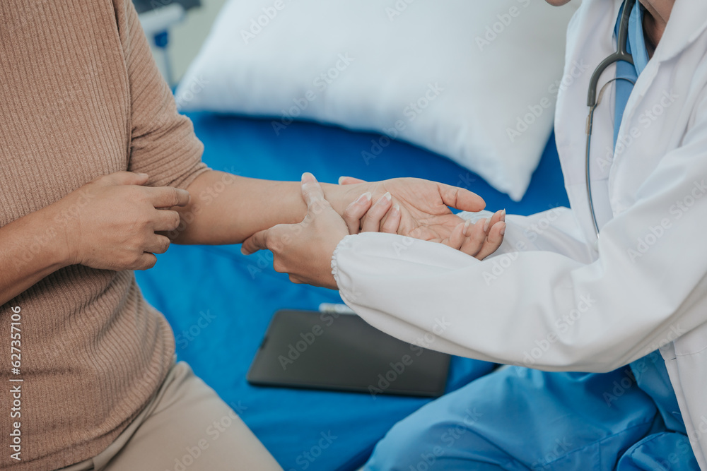 Young beautiful smiling doctor nurse caring to help happy senior grandmother helping old patients in rehabilitation at elderly health checkup Young beautiful smiling doctor nurse caring to help happy senior grandmother helping old patients in rehabilitation at elderly health checkup