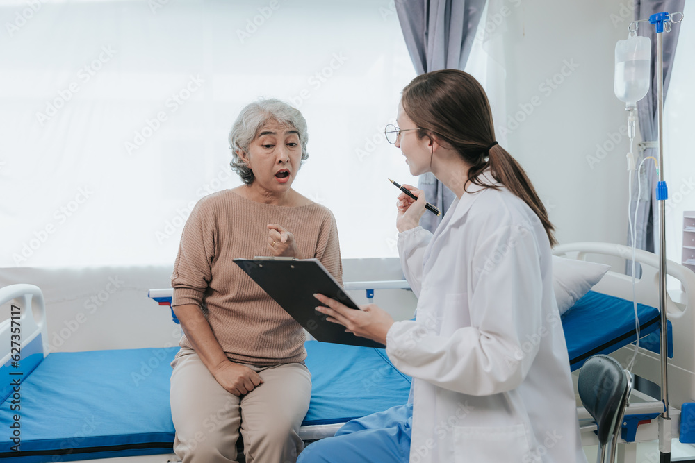 Obraz premium Young beautiful smiling doctor nurse caring to help happy senior grandmother helping old patients in rehabilitation at elderly health checkup