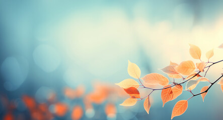 Abstract autumn nature background, with leaves on a branch, glowing sun and warm seasonal colors
