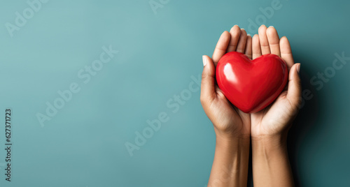 Hand giving red heart , charity symbol photo