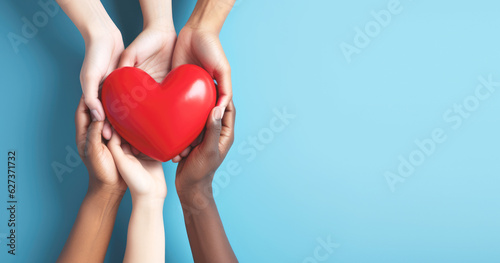 Hand giving red heart , charity symbol photo