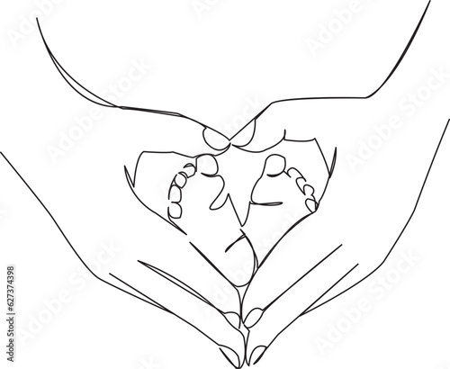 legs of a newborn baby in mother's hands