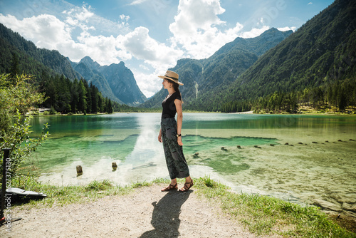 Beautiful female model at lago di dobbiaco in Italy, the dolomites