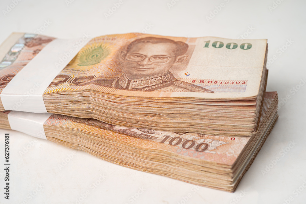Stack of Thai baht banknotes on wooden background, business saving finance investment concept. Stack of Thai baht banknotes on wooden background, business saving finance investment concept.