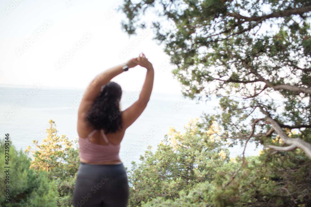 Beautiful woman makes healthy yoga exercises for fot body outdoor in the nature. Young woman dresse sport wear for overweight people. Beautiful woman makes healthy yoga exercises for fot body outdoor in the nature. Young woman dresse sport wear for overweight people.