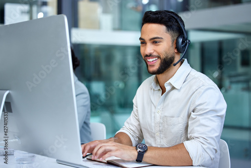 Business man, call center and web support communication at a computer in a office. Phone conversation, smile and male worker with contact us, crm and customer service job in a consulting agency