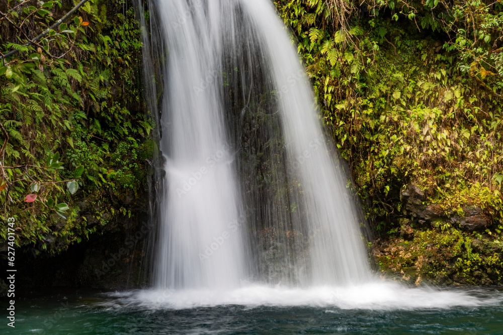 Close-up view of a cascading waterfall along the Road to Hana, scenic route; Maui, Hawaii, United States of America Close-up view of a cascading waterfall along the Road to Hana, scenic route; Maui, Hawaii, United States of America
