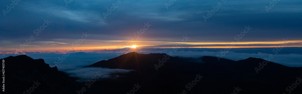 Scenic view of Haleakala from mountain top overlooking the Pacific Ocean above the clouds at sunrise; Haleakala National Park, Maui, Hawaii, United States of America