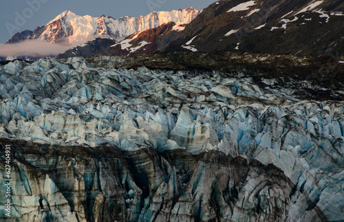 Close up of the Lamplugh Glacier and sunlight on snow-covered a mountain range in Glacier Bay National Park and Preserve, Inside Passage, Alaska, USA; Alaska, United States of America photo