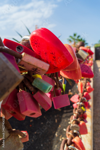 Love lockers hanging on chain at Playa Grande, large beach at Puerto del Carmen, Lanzarote, Canary Islands, Spain photo