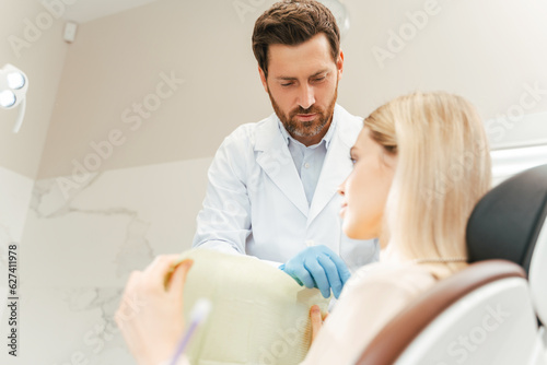 Professional dentist preparing patient woman to checking teeth