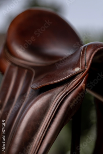 Closeup of a handmade brown leather dressage saddle