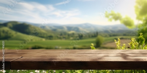 Empty wood table top with on blurred green vineyard landscape background in spring © Jing