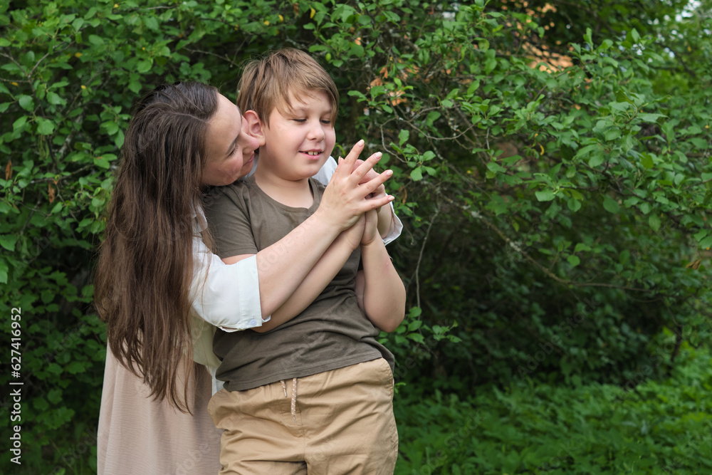 An endearing scene of a mother and son sharing a joke and a hug in a serene garden, highlighting the beauty of natural parent-child connection An endearing scene of a mother and son sharing a joke and a hug in a serene garden, highlighting the beauty of natural parent-child connection