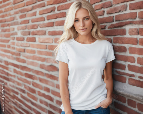 T-shirt mock-up woman in plain white shirt by red brick wall.