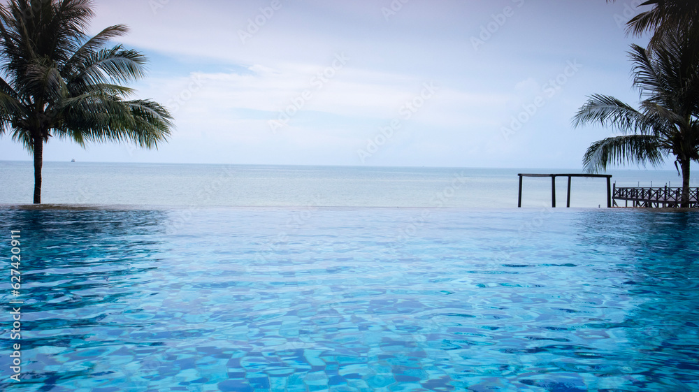 Beautiful infinity swimingpool with ocean view.coconut trees, calm blue skies, perfect for clearing your mind on vacation - Belitung Indonesia Beautiful infinity swimingpool with ocean view.coconut trees, calm blue skies, perfect for clearing your mind on vacation - Belitung Indonesia