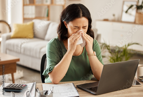 Laptop, remote work and sick woman in home office with flu, cold or viral infection in her house. Freelance, sneeze and lady online with allergy, virus or burnout, sinusitis or hayfever while typing photo