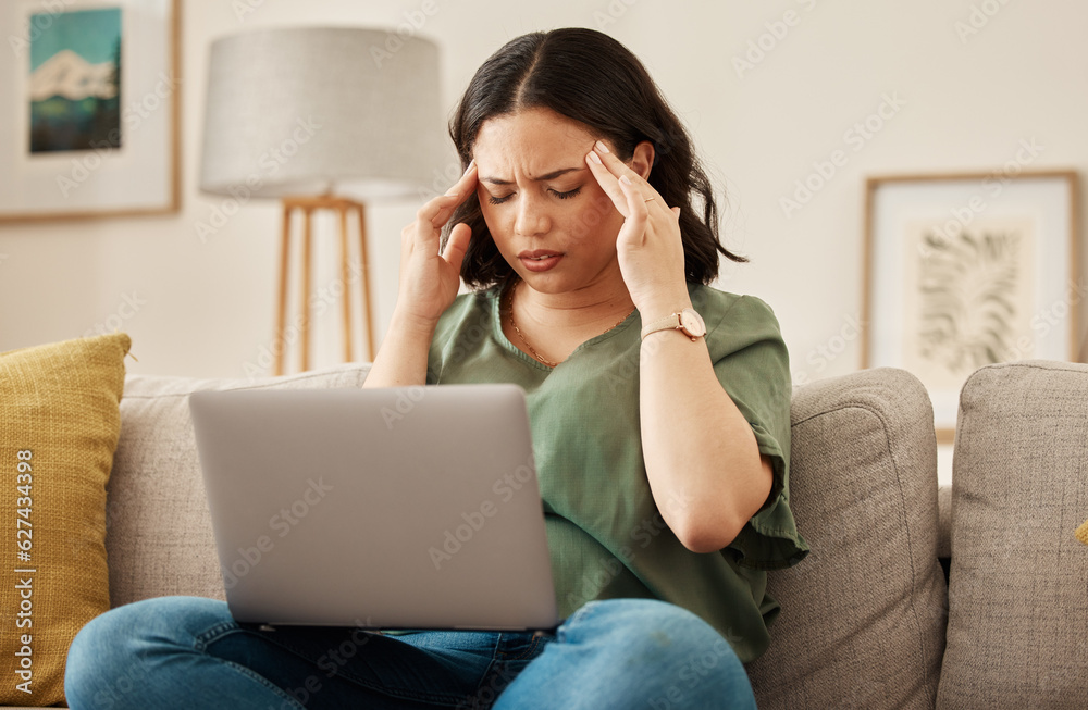 Woman, home and headache with laptop learning and remote work stress on a sofa feeling frustrated. House, female person and confused from computer problem with anxiety from online website project Woman, home and headache with laptop learning and remote work stress on a sofa feeling frustrated. House, female person and confused from computer problem with anxiety from online website project