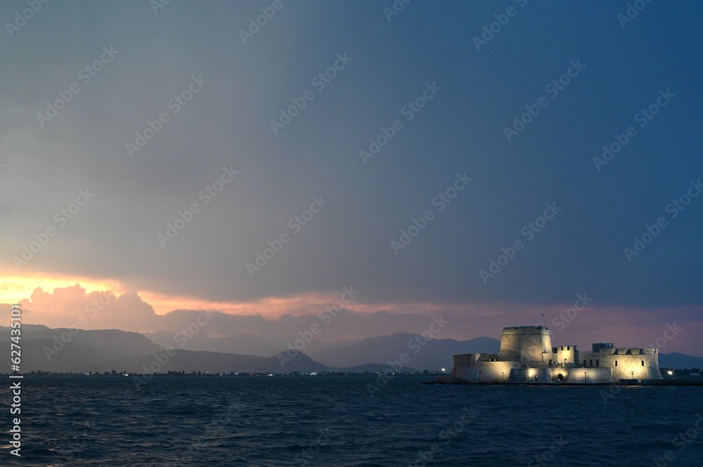 Fototapeta premium Sunset over the castle Bourtzi in Nafplio, Peloponnese, Greece