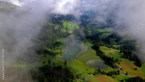 Nature Swiss scenery , Aerial view of beautiful Lauenen (lauenensee) lake surrounded by green feelds and Alps mountains. Aerial drone view. idyllic Swizzerland scenery photo