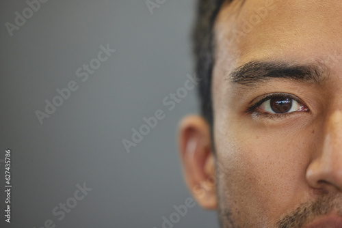Mockup, portrait and half eyes of a man isolated on a grey background in studio. Serious, Asian and closeup face of a person with space for expression, looking handsome and a young eye on a backdrop photo