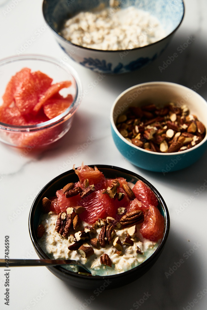 Overnight oats with milk and greek yogurt. healthy breakfast with nuts with grapefruit, honey and cinnamon. Top view Overnight oats with milk and greek yogurt. healthy breakfast with nuts with grapefruit, honey and cinnamon. Top view