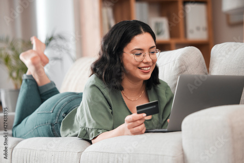 Credit card, computer and woman for home online shopping, e learning and fintech payment on sofa. Relax, student loan and person on laptop banking, study subscription or website transaction on couch