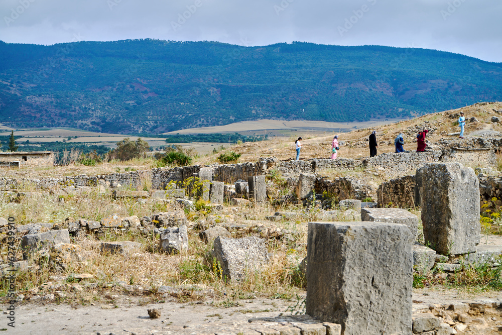 Tourists walking in ancient roman city Volubilis Tourists walking in ancient roman city Volubilis