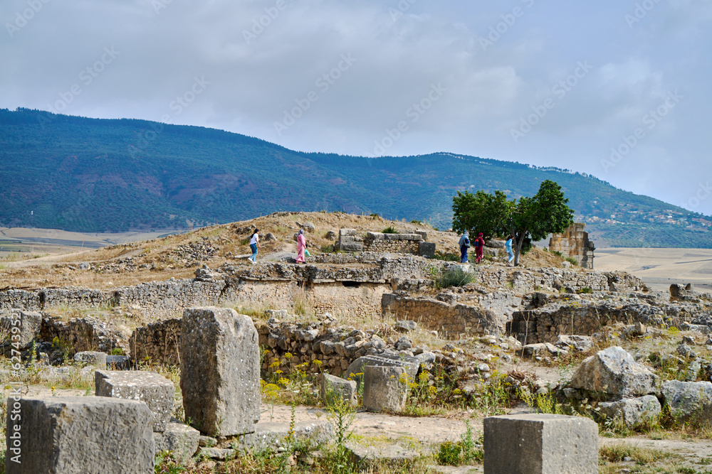 Tourists walking in ancient roman city Volubilis