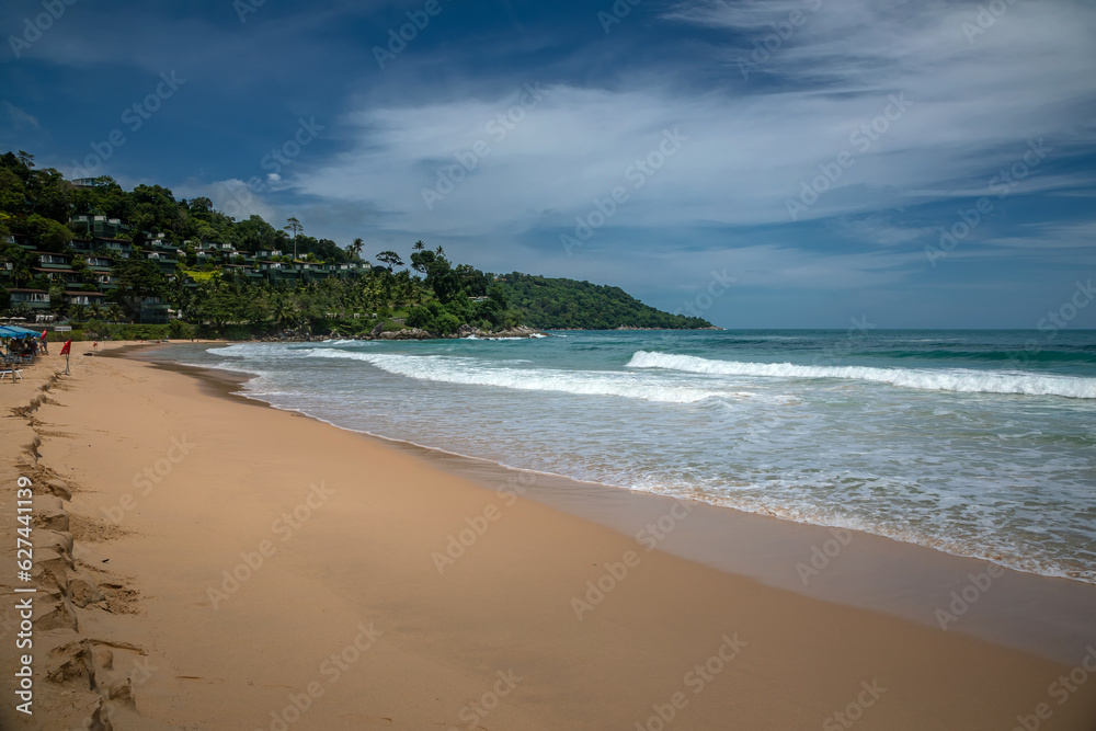 Beautiful beach on a summer day. Blue sky. Sunny day. Yellow sand on the beach.