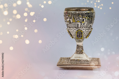 Silver kiddush wine cup and saucer isolated. Shabbat silver kiddush cup. Kiddush cup with the gemstone of 12 tribes. photo