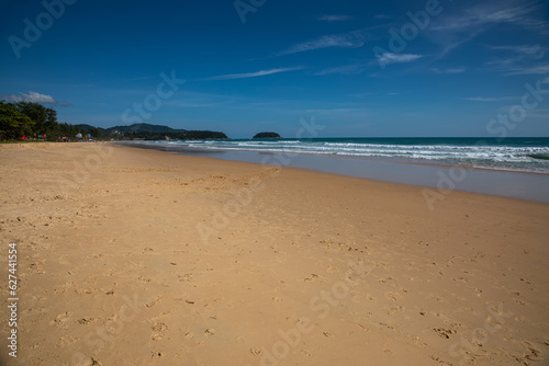 Beautiful beach on a summer day. Blue sky. Sunny day. Yellow sand on the beach.