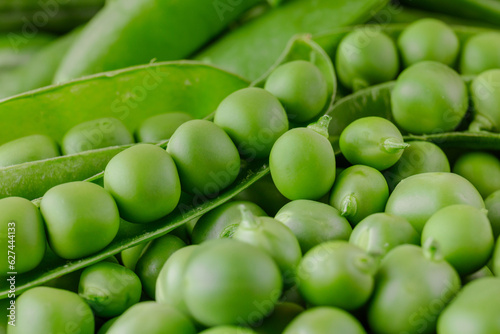 Green pea and pea pods. Peas background. Closeup, macro shot of fresh pea. Pea pod with beans.