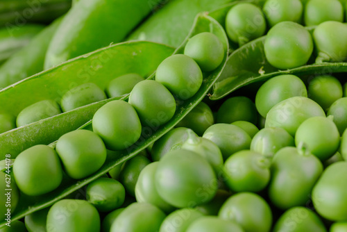 Green pea and pea pods. Peas background. Closeup, macro shot of fresh pea. Pea pod with beans.