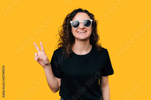Young Woman Making Peace Gesture - Expressing Harmony and Positivity.