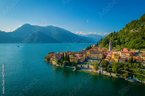 Varenna, Como Lake. Aerial panoramic view of town surrounded by mountains, blue sky and turquoise water and located in Como Lake, Lombardy, Italy photo