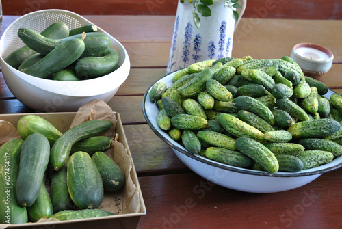 zdjęcie misy pełnej zielonych ogórków i cukinii leżących na stole © Radosaw
