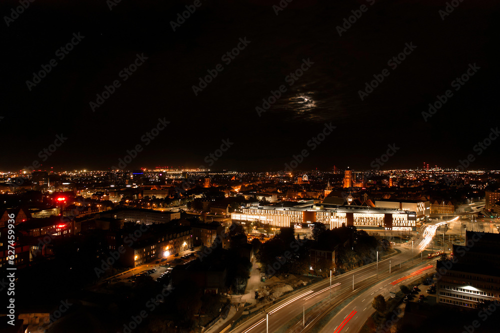 Top down view to road. Romantic night aerial photo of cars traveling. The light on the road at night in city. Background scenic road drone view. Tram railways background