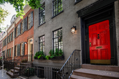 View of a bright red door on a historic brownstone in Manhattan, New York City