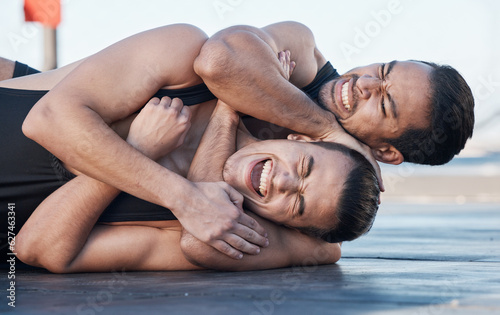 Men fight, mma and choke hold outdoor for competition, exercise and workout. Wrestling, grappling and people in battle, challenge and combat for martial arts, fitness sports and training with pain
